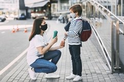 Schoolboy and mother wearing medical masks during a pandemic Product Image 1