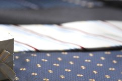 Collection of coiled neckties in display. Product Image 1