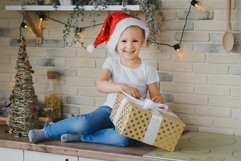 Baby girl in Christmas interior Product Image 1