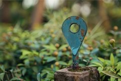 Rusty blue location pin pointing standing in nature Product Image 1