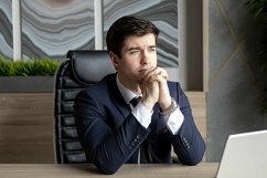portrait of a businessman in a dark blue suit in the office Product Image 1