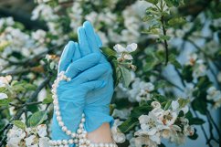 Women&#039;s hands in medical gloves and a pearl bracelet. Product Image 1