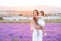 Beautiful woman holding little baby girl in lavender field Product Image 1