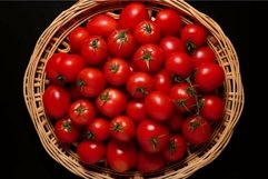 Fresh red tomatoes in wicker basket Product Image 1