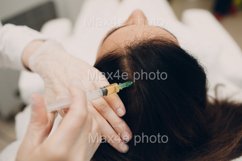 Needle mesotherapy. Cosmetic been injected in woman's head. Product Image 1