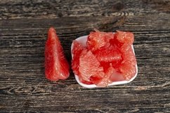 peeled and divided into parts ripe red grapefruit Product Image 1