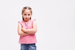 Upset or siriously 6-7 aged girl in the pink T-shirt Product Image 1