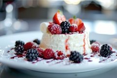 Delicious dessert with berries and cream being served on whi Product Image 1