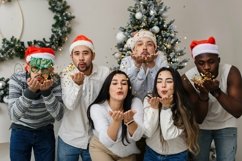 Multiethnic people blowing confetti into the camera Product Image 1