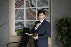 portrait of a businessman in a dark blue suit in the office Product Image 1