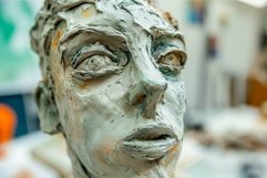 Expressionist clay bust in art studio Product Image 1