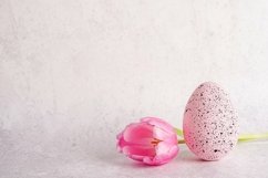 Pink tulip flower and easter egg on light gray concrete Product Image 1