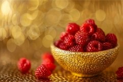 Fresh raspberries in golden bowl with bokeh background Product Image 1