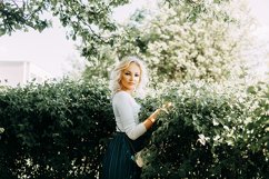 Beautiful young blonde girl in blooming Apple orchard. Product Image 1