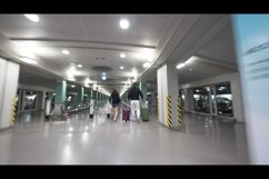Travelers with baggage walking to flat escalator at Seoul ai Product Image 1