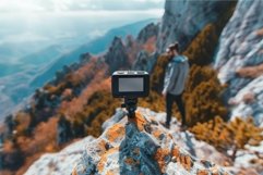 Action camera recording a videographer standing on top of a Product Image 1