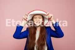 A redhead girl is in hat on the pink background. Product Image 1