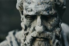 Detailed view of a weathered stone statue depicting an old p Product Image 1
