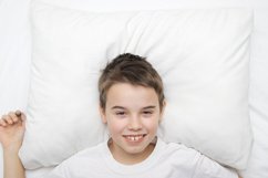 White pillow mock up with smiling boy Product Image 1