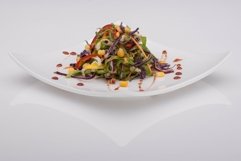 Salad in a white plate on a white background Product Image 1
