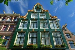 Traditional dutch houses facade in amsterdam with green wall Product Image 1