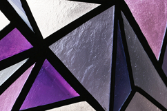 A close-up view of a stained glass window with purple x Product Image 1