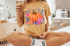 Hand-painted orange pumpkin surrounded by pink, blue, and peach flowers with leafy accents in a whimsical watercolor style on a white background.