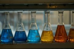 Colorful laboratory flasks on shelf Product Image 1