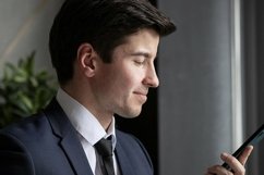 portrait of a businessman in a dark blue suit in the office Product Image 1