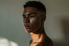 Contemplative young man in dramatic lighting Product Image 1