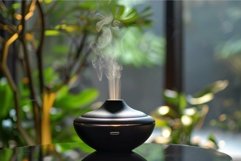 Black aroma diffuser releasing calming fragrance in a green Product Image 1