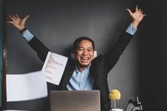 Excited happy and smiling businessman showing winner gesture Product Image 1