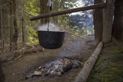 A pot on a fire in the forest Product Image 1