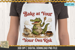 Cute crocodile wearing an apron holding spoons in a messy kitchen with spilled batter, broken eggs, and the quote &quot;Bake at Your Own Risk.&quot;