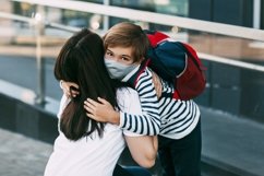 Schoolboy and mother wearing medical masks during a pandemic Product Image 1
