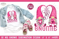 Watercolor painted pink gnomes with a hat heart shape Be My Gnomie text on a white valentine shown on a white t-shirt with pink tennis shoes and a blue jean jacket