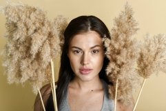 Natural cosmetics concept. Woman with dry grass on backgroun Product Image 1