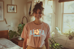 Tropical “Aloha On My Mind” design featuring bold teal college-style lettering with coral outline and a yellow hibiscus flower in the center, slightly distressed texture on a white background