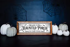 Haunted porch SVG design featuring black vintage typography, bats, spider webs, and a long horizontal sign layout for Halloween decor projects.