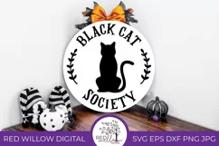 Simple black cat design on a round wooden sign.
