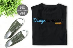 Black folded T-Shirt mock up flat lay with green plant decoration PSD smart object full wrap