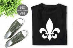 Black folded T-Shirt mock up flat lay with green plant decoration