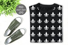 Black folded T-Shirt mock up flat lay with green plant decoration