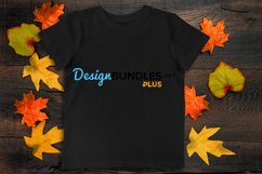 Black t-shirt on dark autumn background red yellow laeves decoration