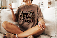 Spooky book lover SVG design featuring “In My Haunted Reader Era” in black script and gothic lettering with bats and web details.