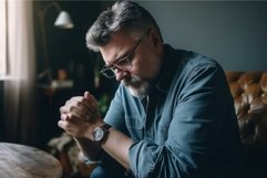 Mature man looking on wedding ring after conflict. Generate Product Image 1