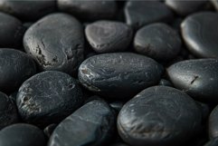 Polished black pebbles are forming a relaxing zen background Product Image 1
