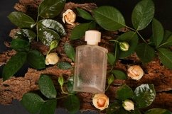 Perfume bottle on nature wooden background with flowers rose Product Image 1