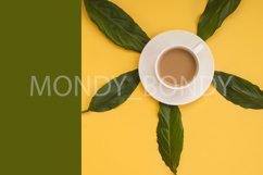 Green leaves, white cup of coffee, yellow, green background. Product Image 1