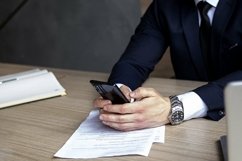 portrait of a businessman in a dark blue suit in the office Product Image 1